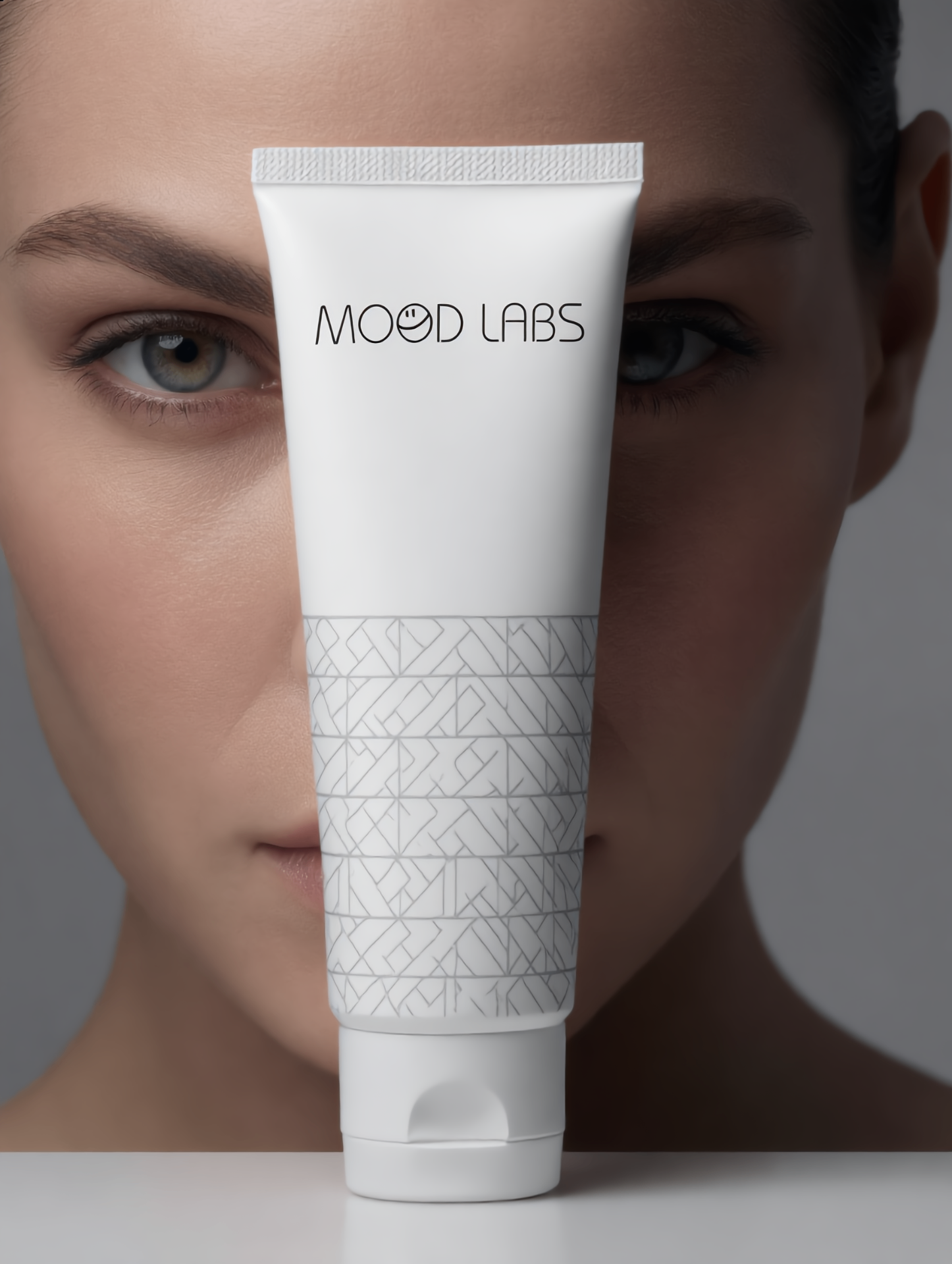 Mood Labs cream tube held over a model's face
