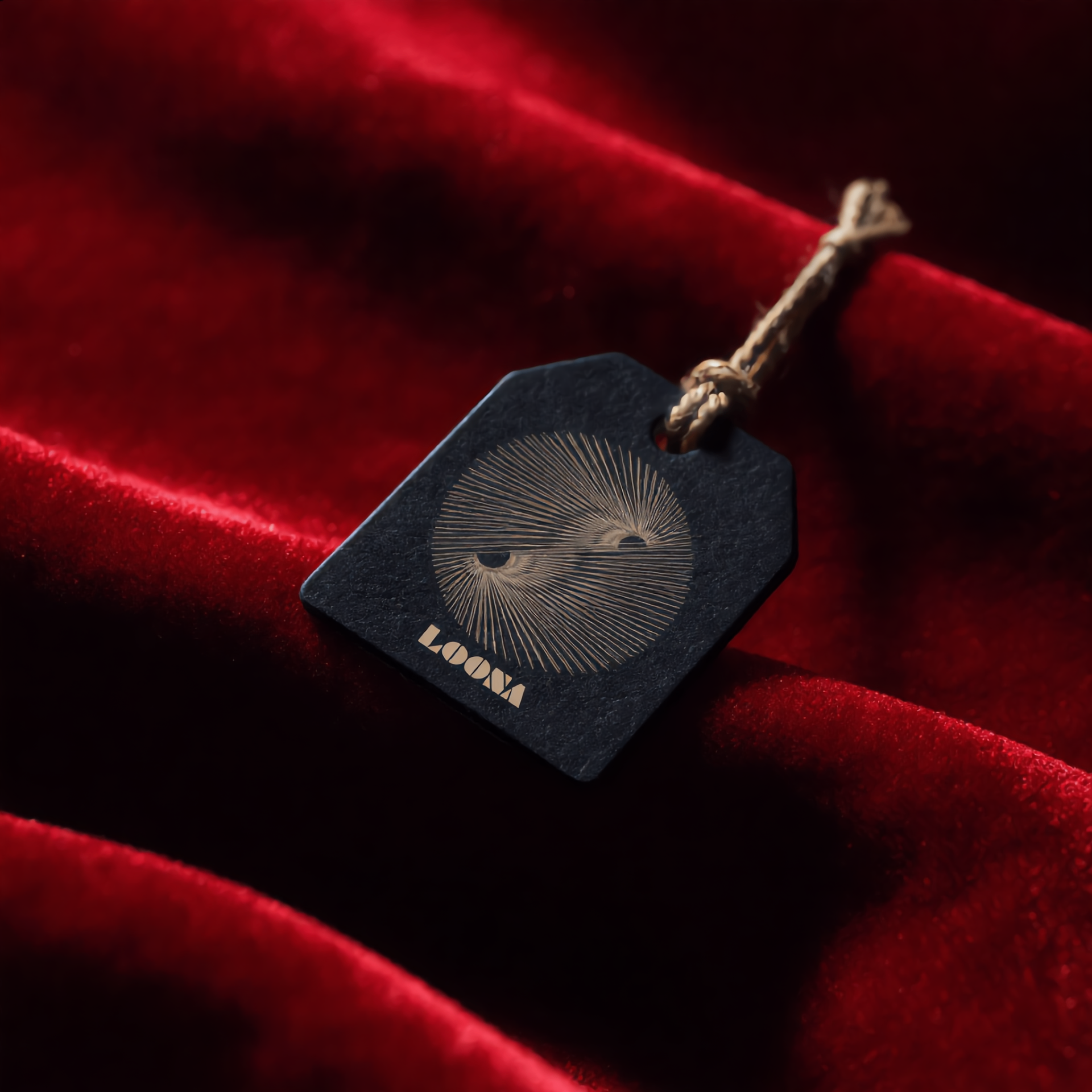 LOONA stone tag resting on folds of red velvet
